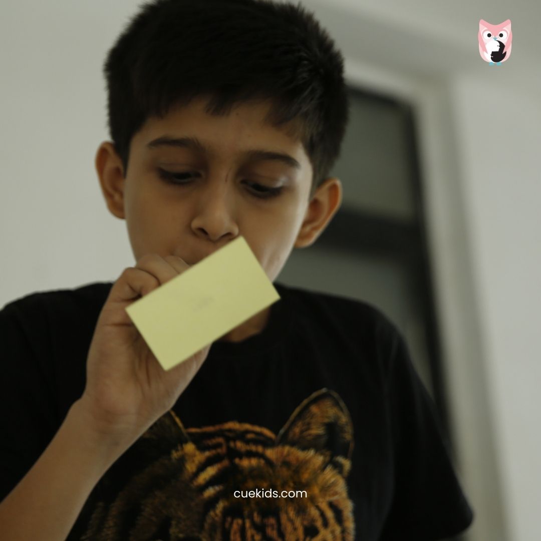 CueKids Child Engaged in Creative Craft Activity